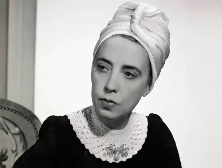 Vogue-1940-Designer-Elsa-Schiaparelli-wearing-black-silk-dress-of-her-own-design-and-a-turban